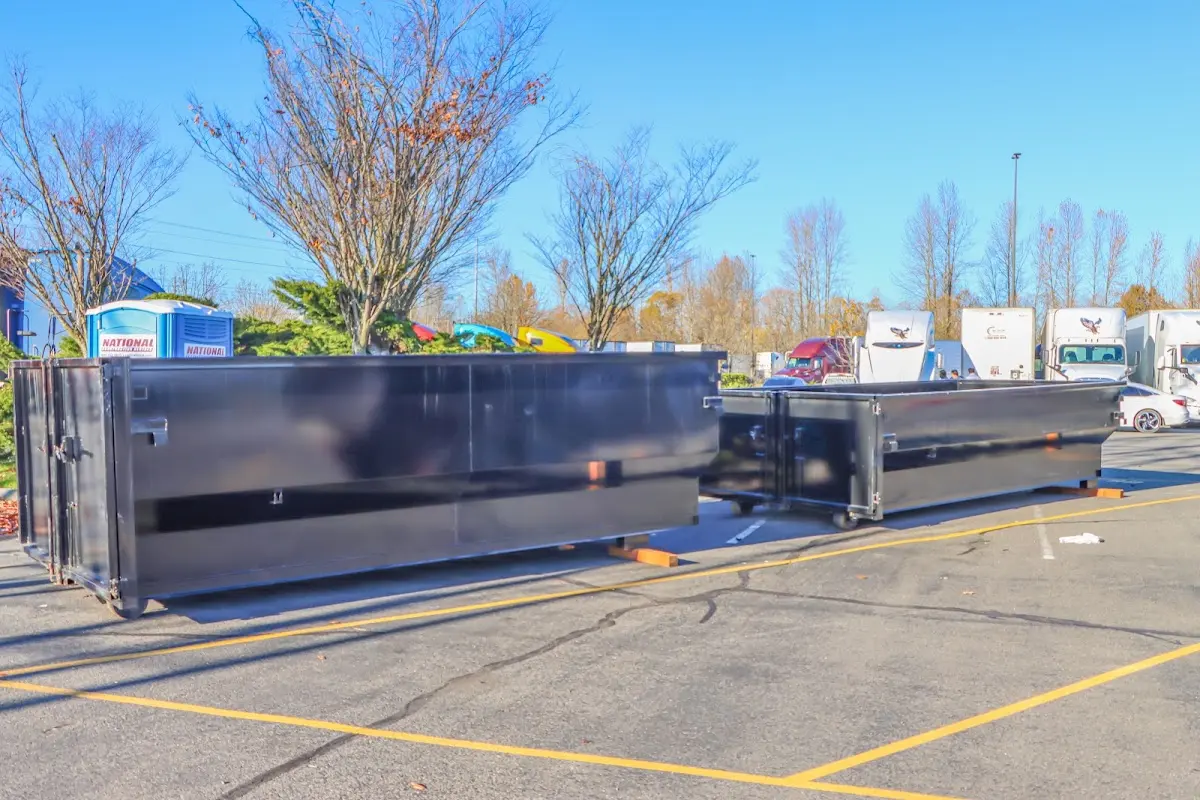 Professional dumpster rental service with roll-off container on residential driveway in Floresville